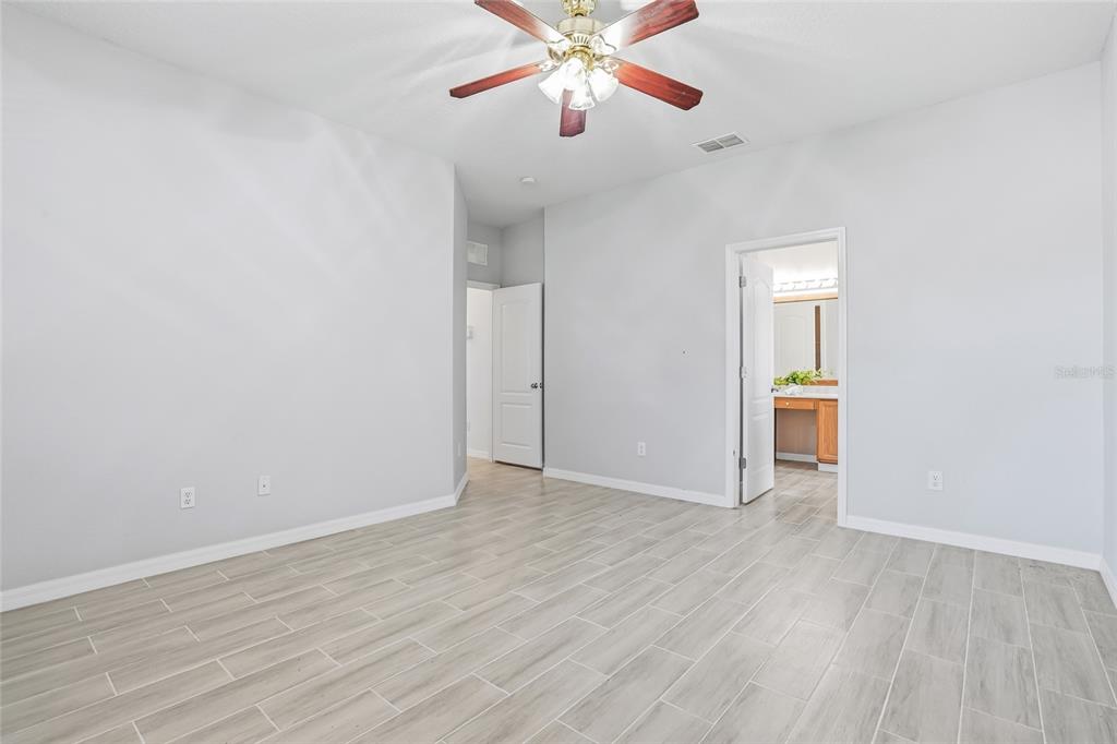 12351 Ridgedale Drive Hudson, FL 34669 - Photo 20 of 48 a view of an empty room with window and wooden floor
