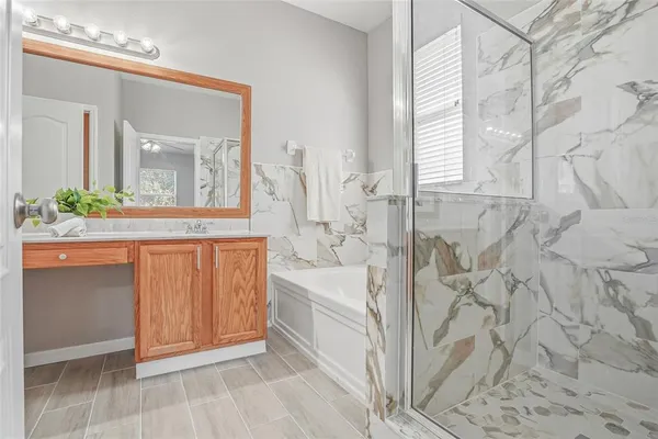 a spacious bathroom with a bathtub and a sink