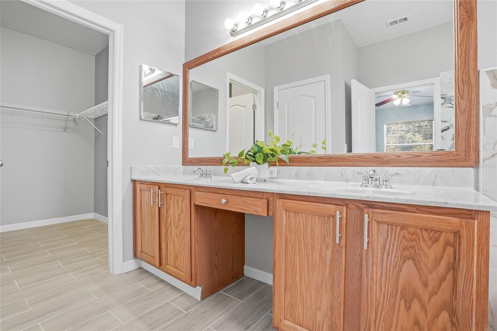 12351 Ridgedale Drive Hudson, FL 34669 - Photo 23 of 48 a bathroom with a granite countertop sink and a mirror