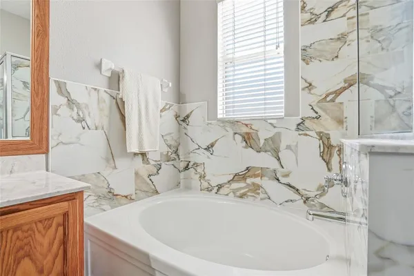 a bathroom with a bathtub and a sink