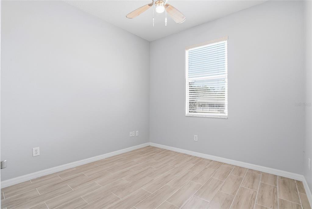 12351 Ridgedale Drive Hudson, FL 34669 - Photo 27 of 48 wooden floor in an empty room with a window