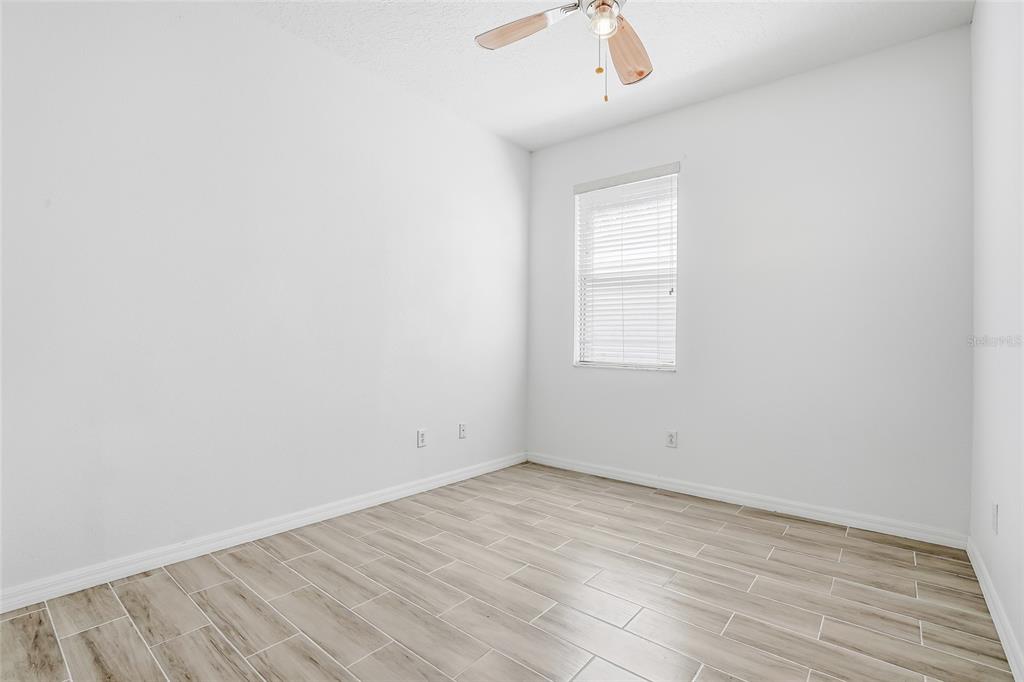 12351 Ridgedale Drive Hudson, FL 34669 - Photo 30 of 48 an empty room with wooden floor and windows