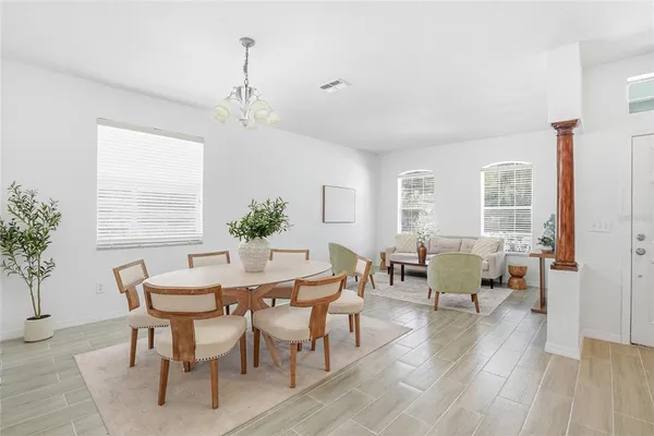a view of a dining room with furniture window and wooden floor