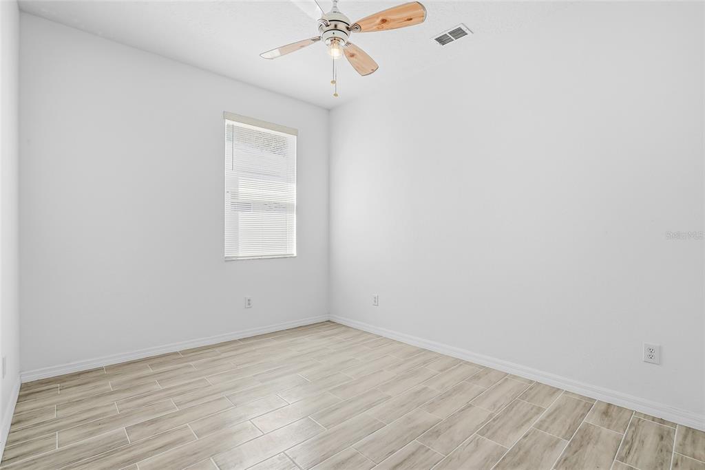 12351 Ridgedale Drive Hudson, FL 34669 - Photo 34 of 48 an empty room with a window and a ceiling fan