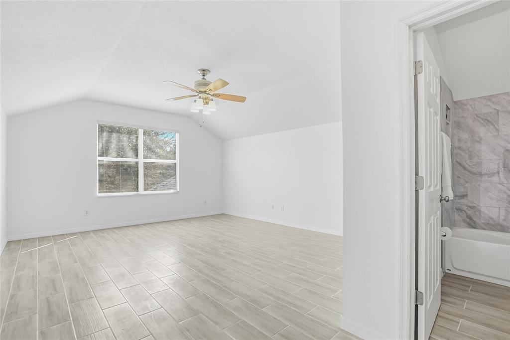 12351 Ridgedale Drive Hudson, FL 34669 - Photo 36 of 48 wooden floor in an empty room with a window