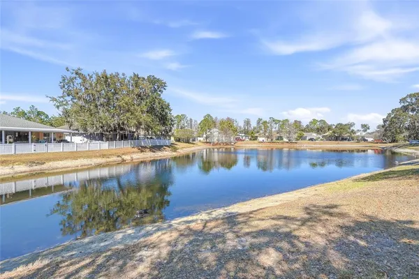 a view of a lake with houses in the back