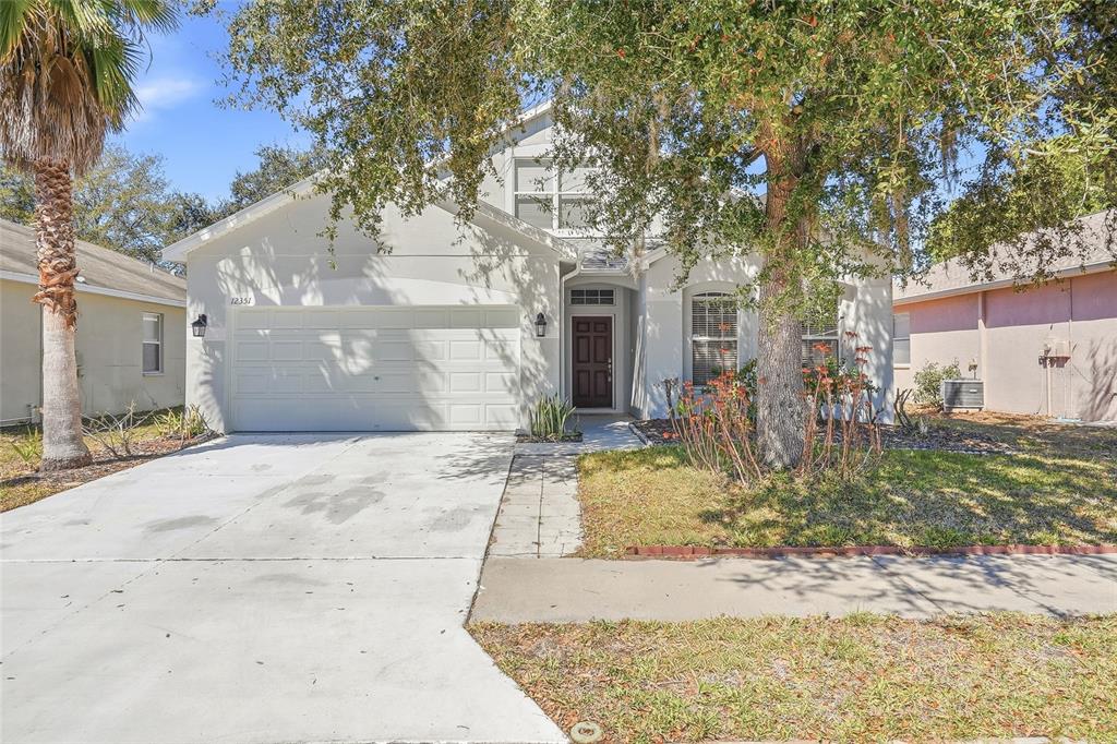 12351 Ridgedale Drive Hudson, FL 34669 - Photo 47 of 48 a view of a white house with a large tree