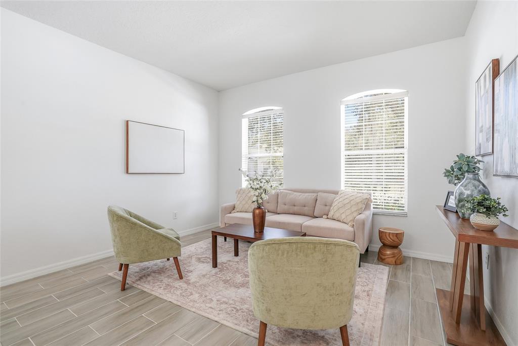 12351 Ridgedale Drive Hudson, FL 34669 - Photo 5 of 48 a living room with furniture and a potted plant