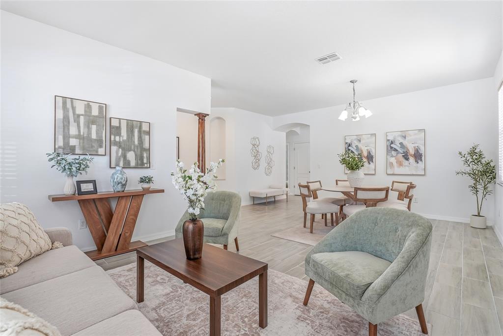 12351 Ridgedale Drive Hudson, FL 34669 - Photo 5 of 48 a living room with furniture and a potted plant