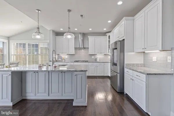 a large kitchen with cabinets stainless steel appliances and a counter space