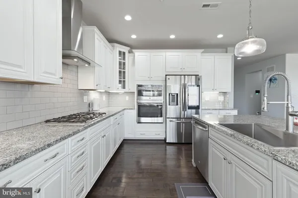 a kitchen with a counter a sink and living room view