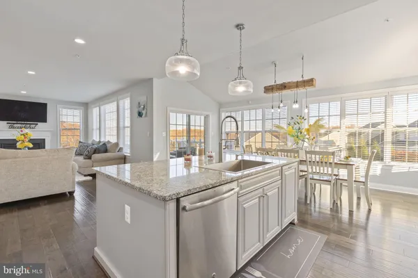 a kitchen with counter top space and wooden floor