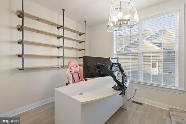 a spacious bedroom with a bed and ceiling fan