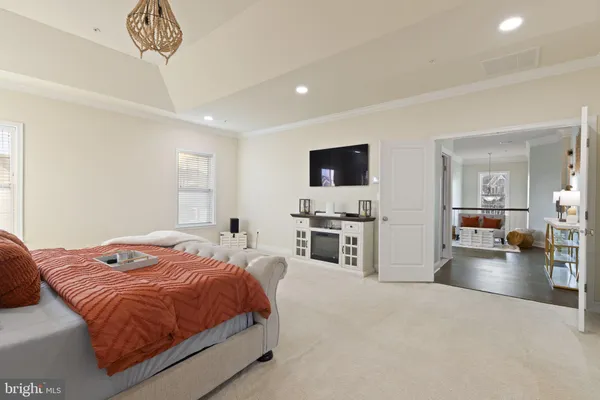 a bed sitting in a bedroom next to a bathroom