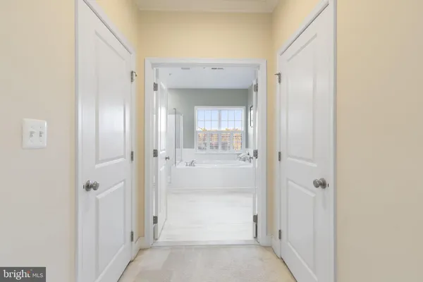 a bedroom with a bed a flat screen tv and windows