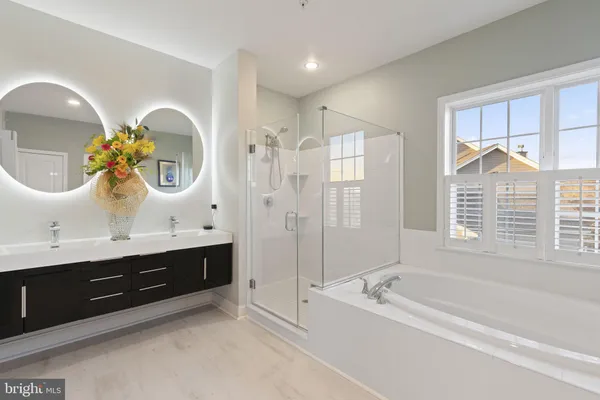 a bedroom with two beds and large window