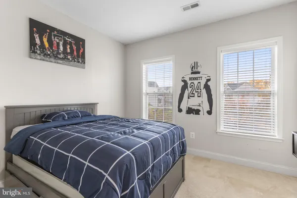 a spacious bedroom with a bed and a couch