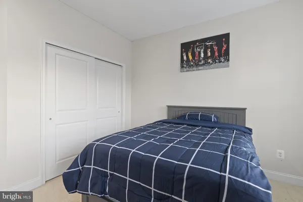 a spacious bedroom with a bed a couch and a view of living room