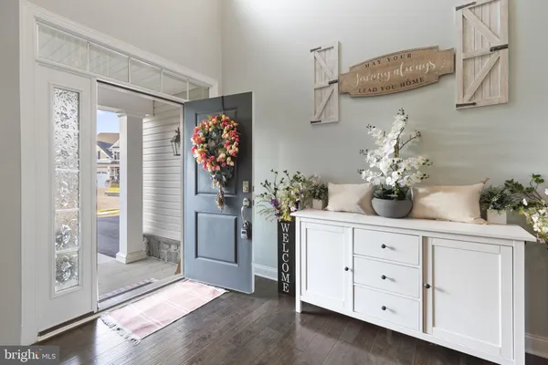 a view of an entryway with wooden floor
