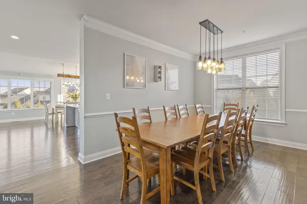 a kitchen with stainless steel appliances granite countertop a sink a stove a refrigerator and white cabinets