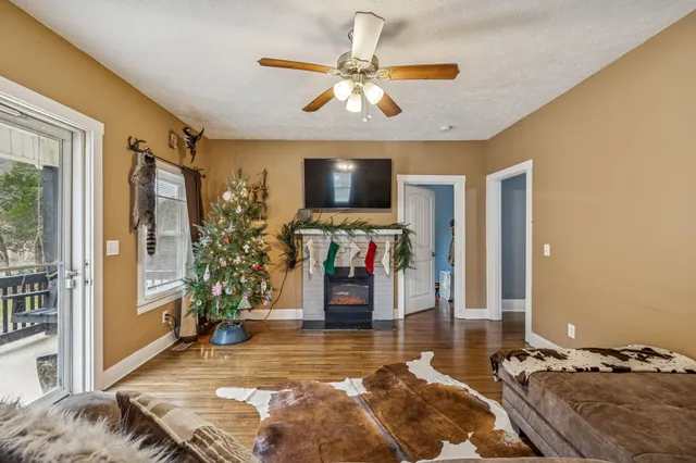 a living room with fireplace furniture and a flat screen tv