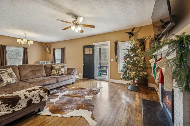 a living room with furniture and a chandelier