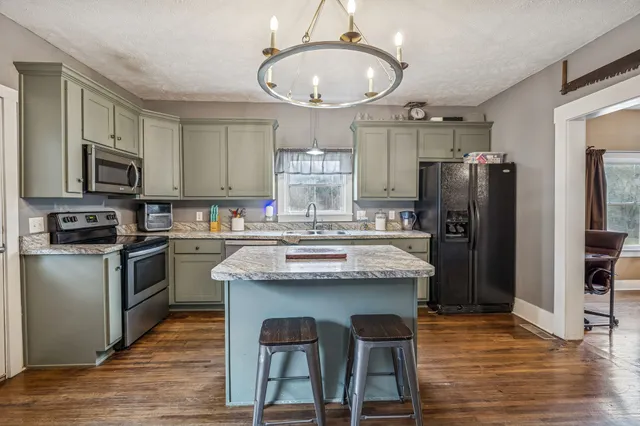 a bathroom with a sink a large mirror and a bathtub