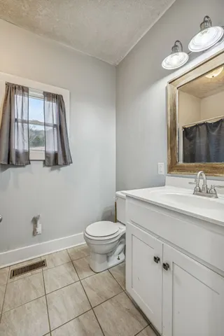 a view of a house with a yard and sitting area