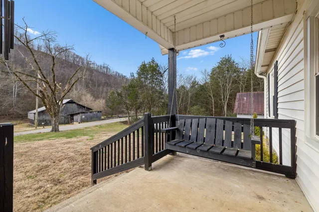 a view of a house with a small yard and wooden fence