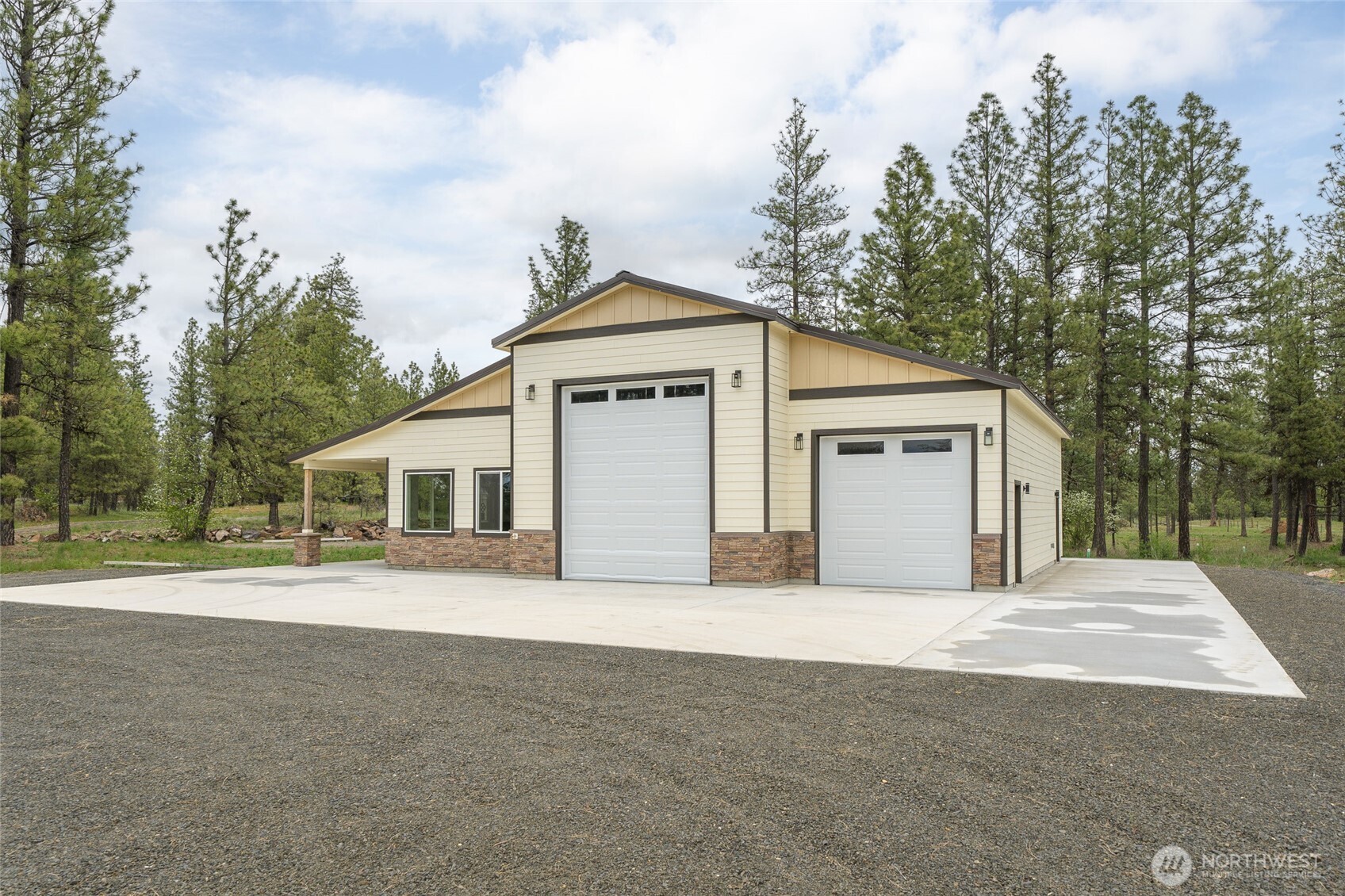 35315 South Bootstrap Lane Cheney, WA 99004 - Photo 25 of 27 a front view of a house with a yard and garage
