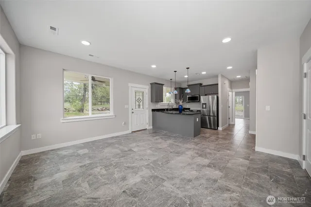 a view of kitchen with kitchen island a sink wooden floor and center island