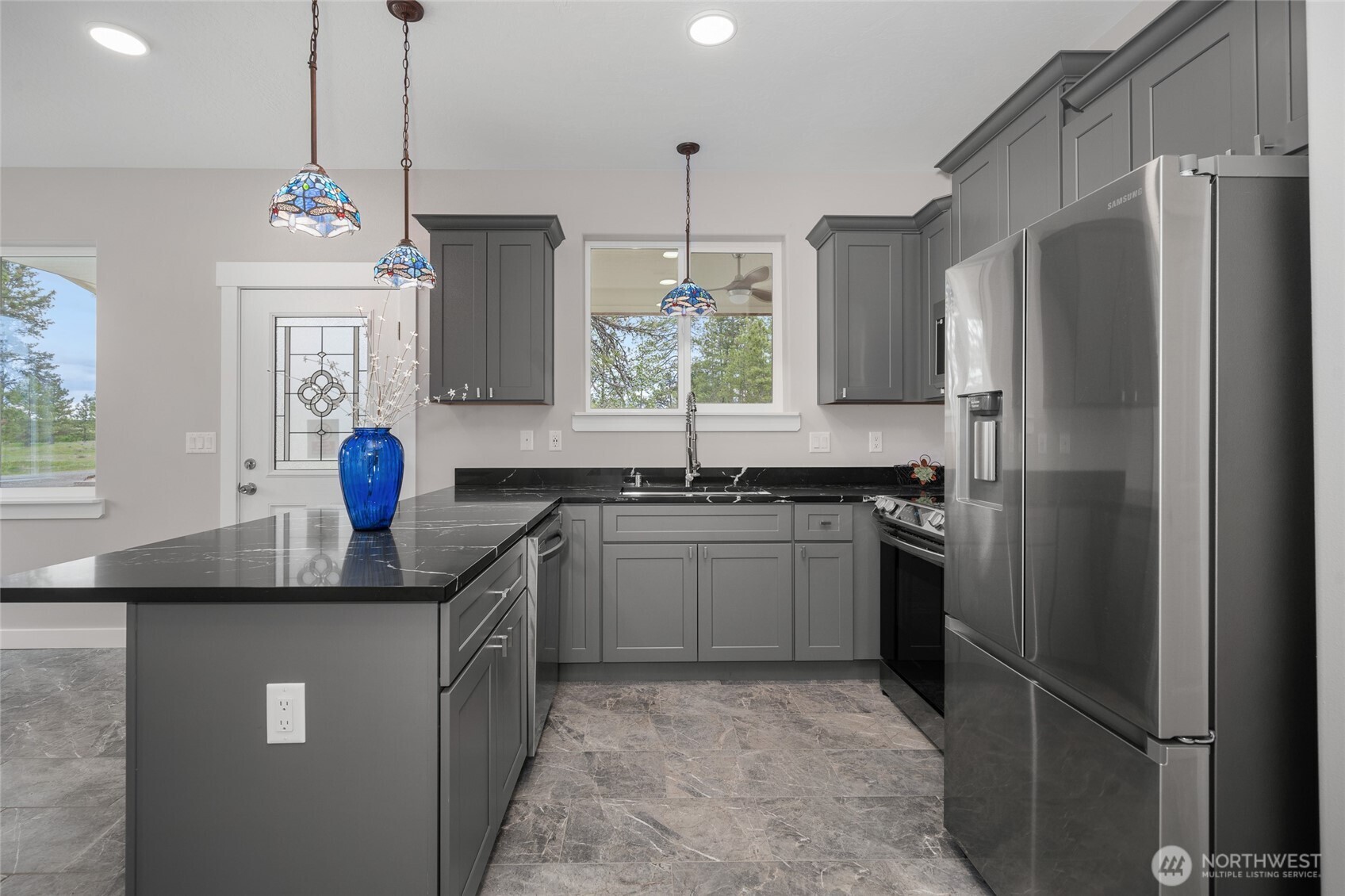 35315 South Bootstrap Lane Cheney, WA 99004 - Photo 7 of 27 a kitchen with granite countertop a sink stainless steel appliances and cabinets