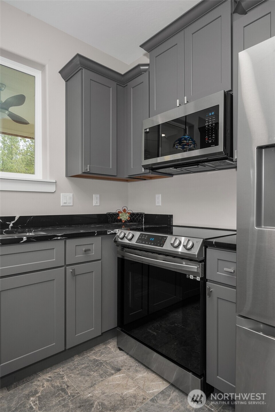 35315 South Bootstrap Lane Cheney, WA 99004 - Photo 8 of 27 a kitchen with stainless steel appliances granite countertop a stove and a microwave