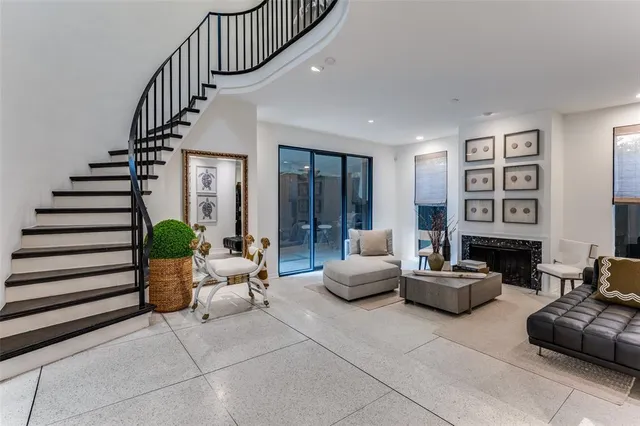 a living room with furniture and stairs
