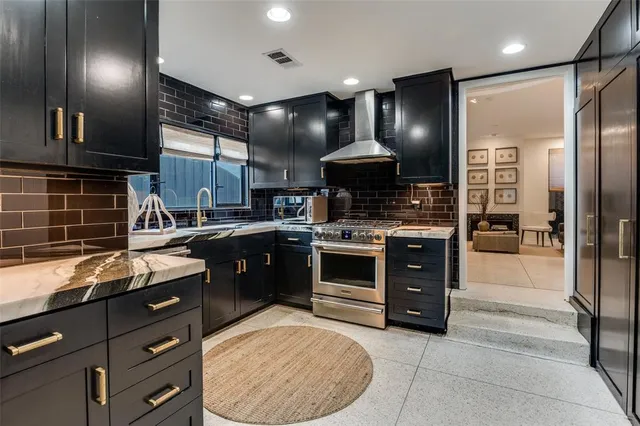 a kitchen with stainless steel appliances granite countertop a stove and a sink