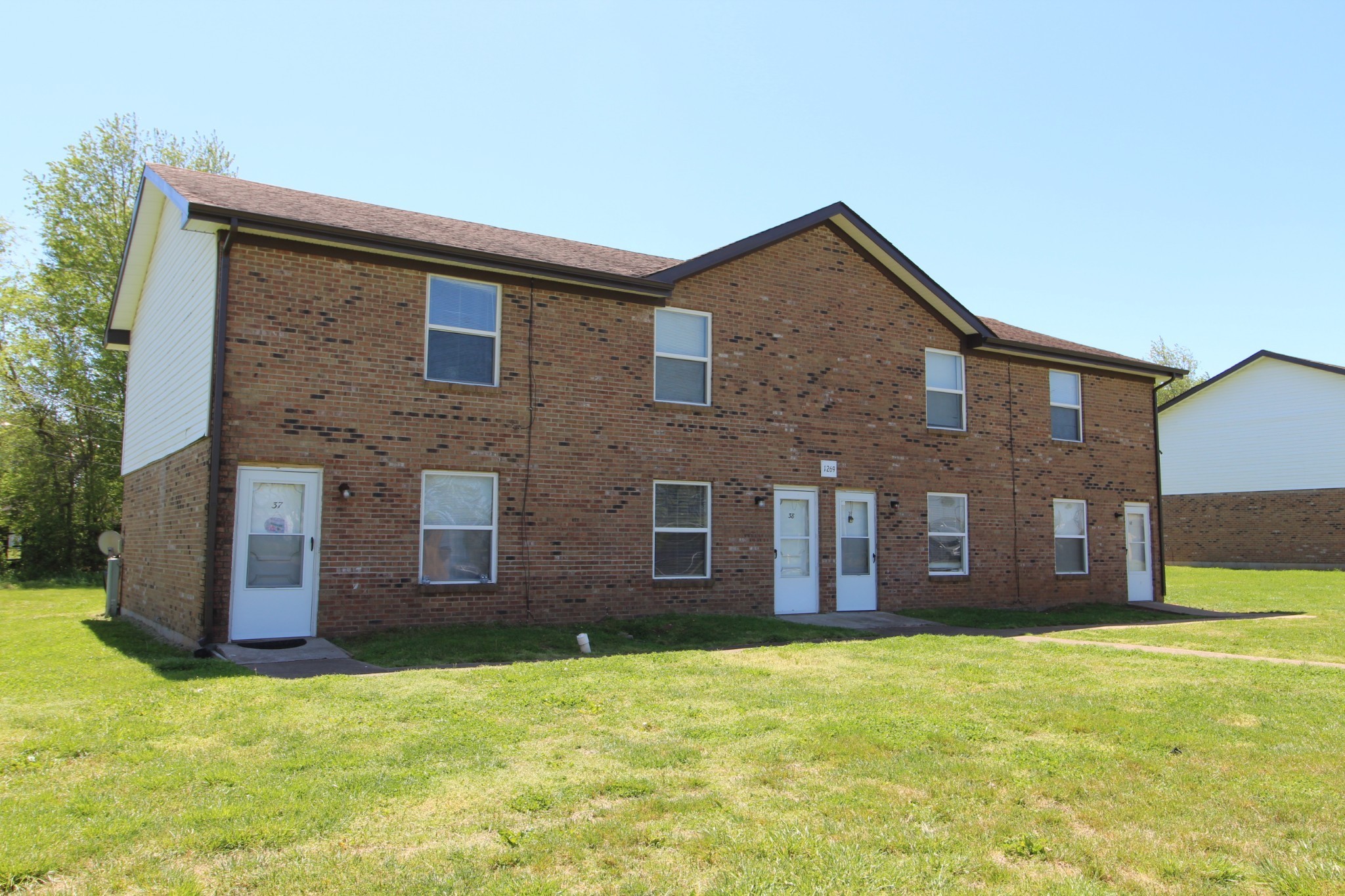 1269 State Line Road, Unit 39 Oak Grove, KY 42262 - Photo 1 of 1 a brick house with a yard in front of it