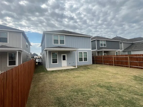 a view of a house with many windows and a yard