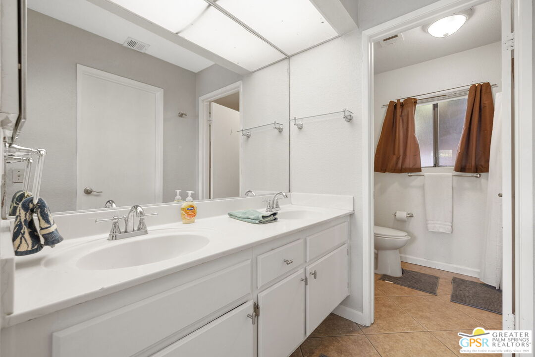 45688 Sutter Creek Road Indio, CA 92201 - Photo 26 of 51 a bathroom with a double vanity sink and a mirror