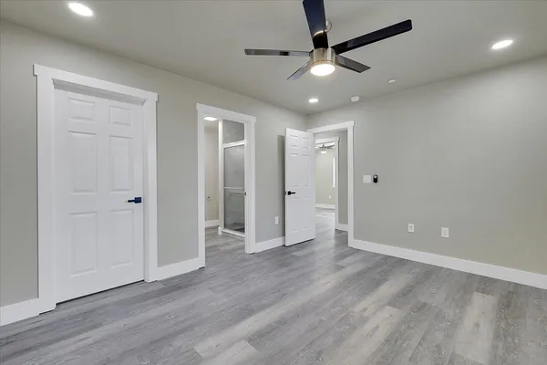 a view of an empty room and wooden floor
