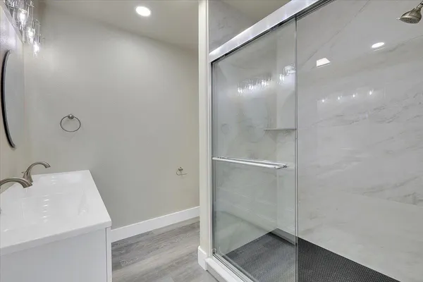 a bathroom with a sink and shower