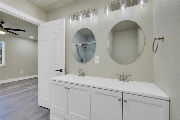 a bathroom with a double vanity sink and a mirror