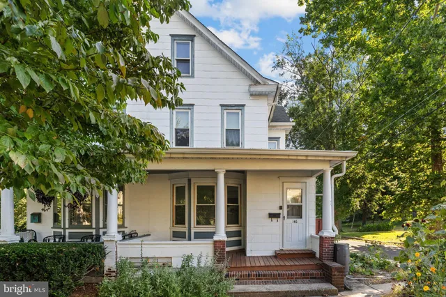 front view of a house with a tree