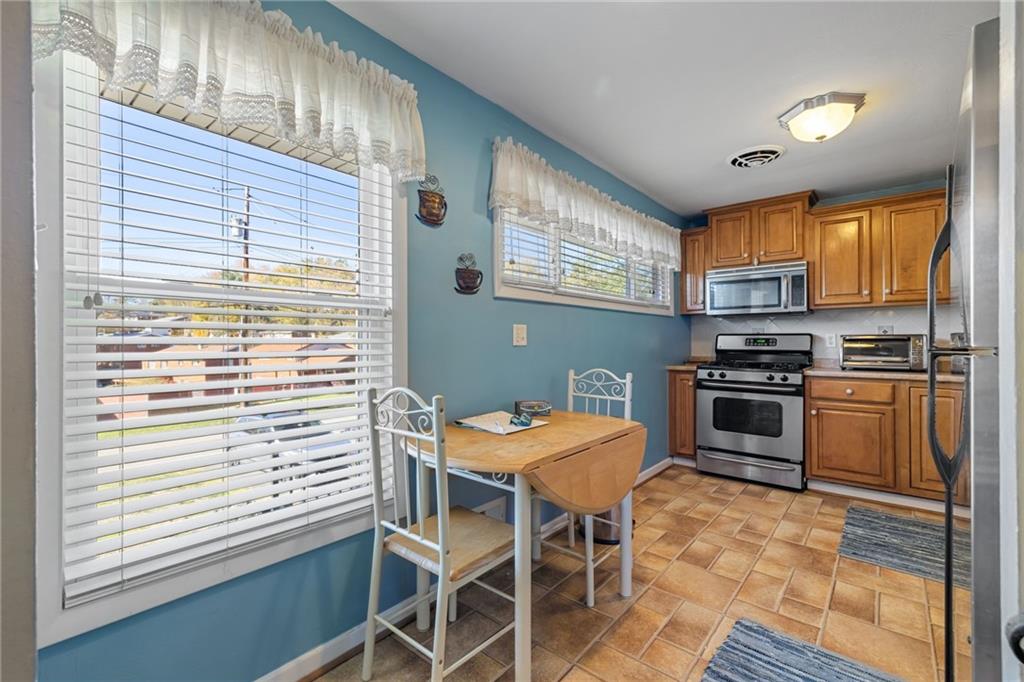 587 Firethorne Drive Monroeville, PA 15146 - Photo 11 of 29 a kitchen with a stove a sink and a microwave