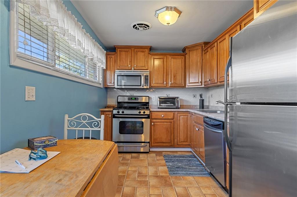 587 Firethorne Drive Monroeville, PA 15146 - Photo 12 of 29 a kitchen with stainless steel appliances granite countertop a stove a sink and a refrigerator