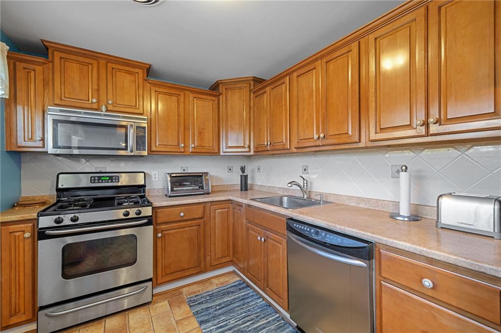 587 Firethorne Drive Monroeville, PA 15146 - Photo 13 of 29 a kitchen with a sink stove top oven and cabinets