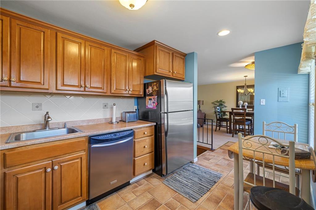 587 Firethorne Drive Monroeville, PA 15146 - Photo 14 of 29 a kitchen with stainless steel appliances granite countertop a sink stove and refrigerator