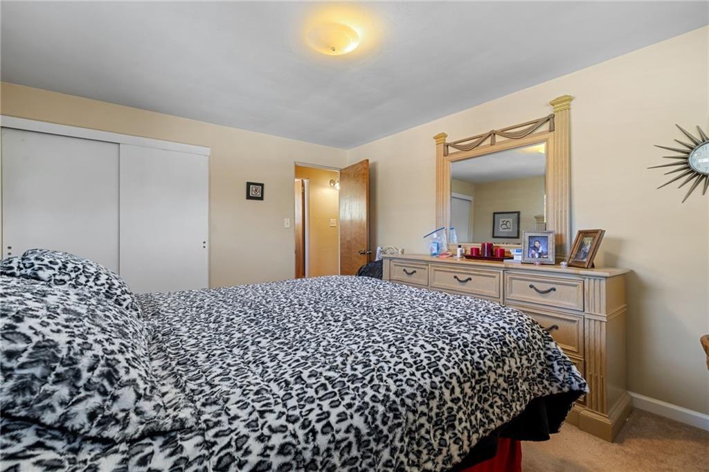 587 Firethorne Drive Monroeville, PA 15146 - Photo 20 of 29 a bedroom with a bed and a mirror on dresser