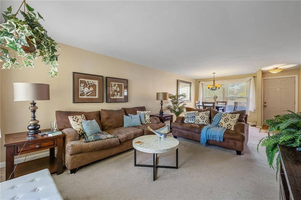 587 Firethorne Drive Monroeville, PA 15146 - Photo 9 of 29 a living room with furniture and a lamp