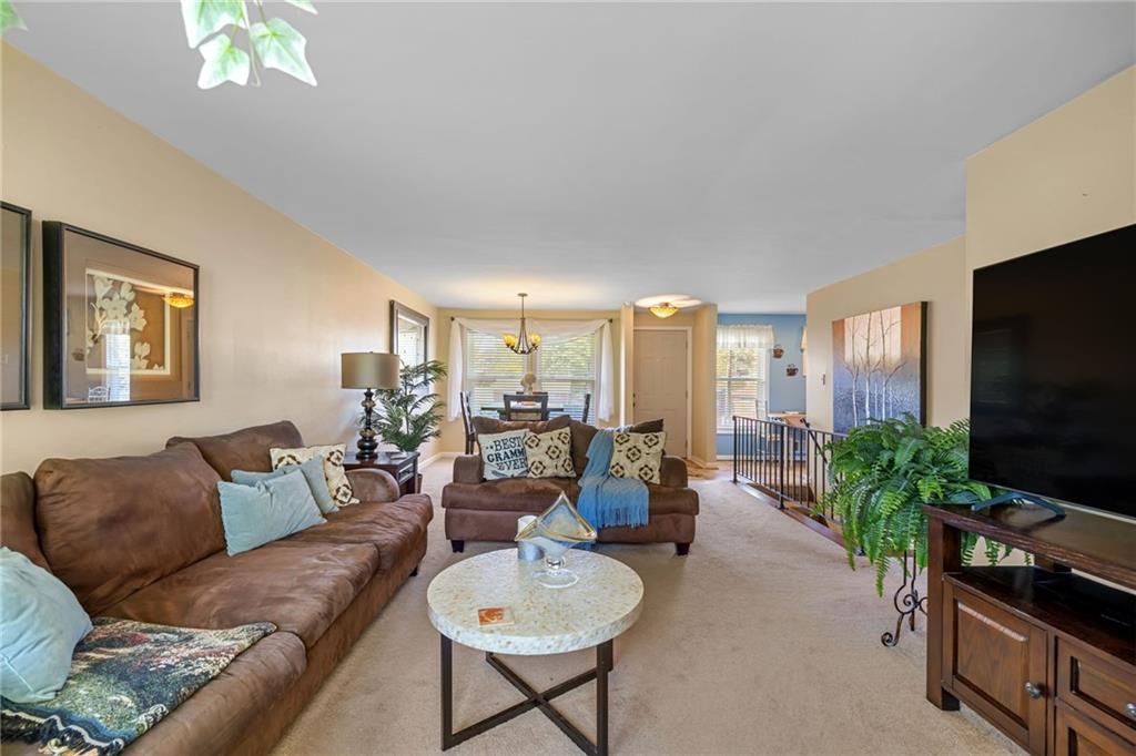 587 Firethorne Drive Monroeville, PA 15146 - Photo 10 of 29 a living room with furniture and a flat screen tv