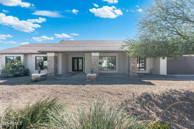 a front view of a house with a yard and a garage